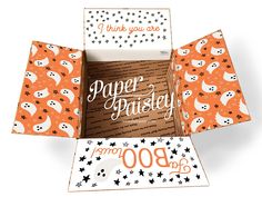 an open box with halloween themed paper on the front and inside, which says thank you are paper poisey