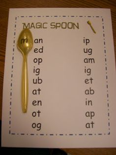 a gold spoon sitting on top of a white paper next to a yellow plastic fork