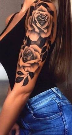 a woman's arm with roses and leaves on it