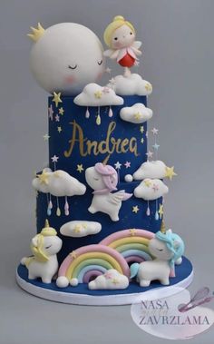 a blue cake with unicorns and stars on it