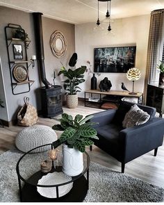 a living room filled with lots of furniture and plants on top of a coffee table