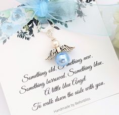 a card with an angel charm attached to it