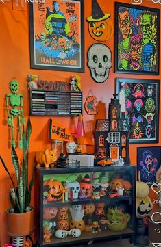 an orange room with halloween decorations and pictures on the wall