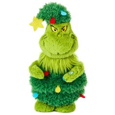 a green stuffed animal wearing a christmas tree costume