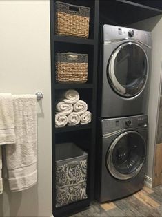 a washer and dryer sitting next to each other in a room with towels