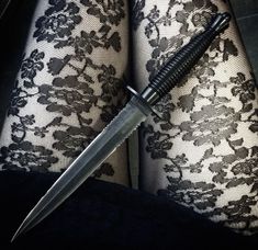 a black and white lace garter with a knife stuck in it