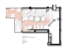 the floor plan for an office with several tables and chairs, including one in pink