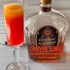 a bottle of crown sunset next to a glass filled with orange juice