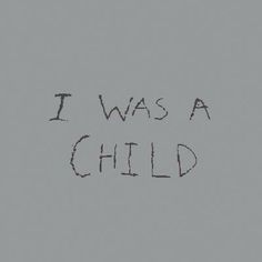 the words i was a child written in black ink on a gray background