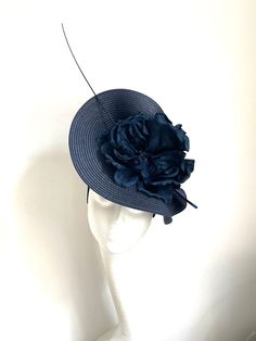 Navy blue saucer disc hat Navy blue saucer disc hat made of navy blue color polybraid base to which I attached navy blue flower and a feather. It has a navy headband with a comb attached for extra security. It will fit the average head size. You can wear this fascinator at a wedding, Christening, or Garden party  Kristine xx Navy Formal Hat With Curved Brim, Navy Curved Brim Formal Hat, Blue Mini Hats With Handmade Flowers And Adjustable Fit, Adjustable Blue Mini Hats With Handmade Flowers, Elegant Navy Hats With Curved Brim, Elegant Navy Hat With Curved Brim, Blue Adjustable Fascinator For Garden Party, Navy Party Hat For Kentucky Derby, Navy Hat For Kentucky Derby Party