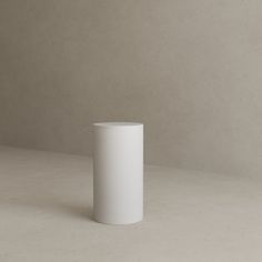 a white cup sitting on top of a table