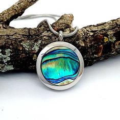 "This Abalone shell keepsake locket opens to hold a momento. Nice for memorial ash, lock of hair or pet fur, dried flowers, sand from the beach, etc. Fill it with anything meaningful to you.  *Choose the abalone that you like best, and I will set it in a locket for you.  You will receive the abalone on a locket that you choose.  *This is a 25mm  (1\") round all stainless steel & glass  locket with an inner depth of about 1/8\". It easily unscrews in half for easy filling. Nice size & weight for everyday wear.  *INCLUDES: 1 Abalone locket Chain choice Glue to seal your locket  Www.thoughtfullkeepsakes.etsy.com  *Your keepsake is nicely displayed through the back glass.  *I offer a nice selection of quality 2mm stainless steel chains with lobster clasp closures. No worries about tarnishing o Adjustable Stainless Steel Keepsake Jewelry, Abalone Shell Round Pendant Jewelry Gift, Adjustable Abalone Shell Necklaces As Gift, Adjustable Abalone Shell Jewelry Gift, Adjustable Abalone Shell Jewelry For Gifts, Adjustable Round Keepsake Jewelry, Shell Locket, Lock Of Hair, Urn Jewelry