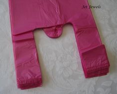 a large pink piece of clothing sitting on top of a white tablecloth covered floor