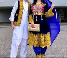 This authentic Afghan couple dress set is a true testament to the beauty and cultural significance of Afghan clothing. The female traditional dress features stunning chamra embroidery and a Balochi chest part that is handcrafted with intricate coins work, adding a touch of elegance and sophistication to the dress. The male vest coat boasts exquisite charma embroidery, a traditional Afghan art form that has been passed down for generations. Crafted by skilled Afghan artisans, this couple dress se Traditional Sets With Embroidered Sleeves For Transitional Season, Traditional Dress With Embroidered Sleeves And Drape, Folk Style Embroidered Dress For Festive Wedding, Folk Style Embroidered Wedding Dress, Folk Style Long Sleeve Embroidered Wedding Dress, Traditional Dresses With Embroidered Sleeves For Eid, Folk Style Long Sleeve Sets For Festivals, Traditional Eid Dresses With Embroidered Sleeves, Traditional Embroidered Dress With Multicolor Sleeves