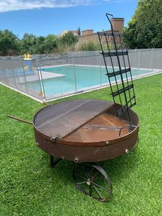 an old wheel barrow with a pool in the background