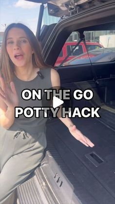 a woman sitting in the back of a car with her hand out and text on the go potty hack