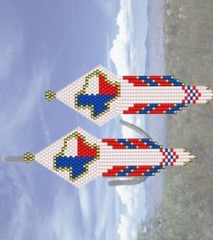 two kites made out of beads are flying in the sky over the ocean and beach