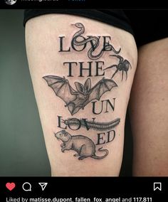 a black and white tattoo on the leg of a woman's thigh that reads, love the un - loved