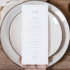 a table setting with white plates and silverware