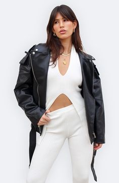 Sorry to all your other leather jackets, because this one wins. The Celine Vegan Leather Moto Jacket features the perfect oversized fit to make you look and feel like the ultimate cool girl. Pair it with your favorite white tank and baggy jeans to instantly elevate your everyday look. COLOR: BLACK DETAILS Faux leather fabric Biker style Oversized fit Asymmetric front zipper fastening Double point collar Lapels on shoulders Zip pockets and cuffs Belted hem with buckle closure Silver hardware Full White Edgy Leather Jacket For Winter, Edgy White Leather Jacket For Winter, Edgy White Outerwear For Fall, White Long Sleeve Edgy Biker Jacket, Oversized Biker Jacket For Spring, Edgy White Leather Jacket For Spring, Trendy White Biker Jacket For Streetwear, White Biker Leather Jacket For Fall, Chic White Outerwear For Streetwear