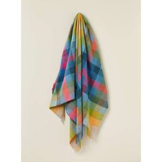 a multicolored plaid scarf hanging on a wall