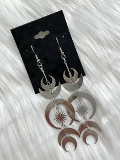 *Moon + star dangle design earring *Silver color *Zinc alloy *Nickel and led free *Fish-hook style *3.25"X1.12" Earring Silver, Moon Star, Silver Earrings Dangle, Fish Hook, Stars And Moon, Silver Color, Zinc Alloy, Silver Earrings, Piercings