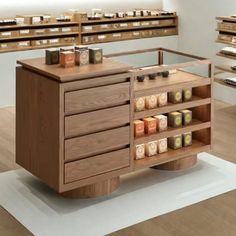 an assortment of candles are on display in a store with shelves and shelvings