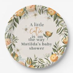 a white plate with oranges and leaves on it that says, a little cafe is on the way matilda's baby shower