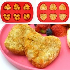 two heart shaped muffins on a pink plate next to strawberries and an apple