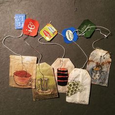 small bags with tags attached to them sitting on the floor next to each other, all decorated in different designs