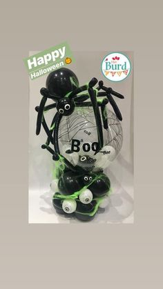 a halloween decoration with black and white balls, bats and spider webs on it