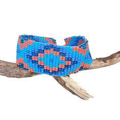 Lovely handmade Huichol beaded bracelet, southwest style,  tribal symbol pattern, light blue, lavender, orange and glitter blue colour, from our Fair Trade partners in Mexico.  Size is approx. between 18.5long cm by 2.5 cm wide. Please also visit my new shop, BALI COCONUT BY ROSA made in Fairtrade partnership with fine Balinese artisans and featuring all natural jewellery: https://www.etsy.com/uk/shop/BaliCoconutbyRosa Spend over $35 US Dollars with us and receive FREE postage for orders to the Artisan Beaded Turquoise Friendship Bracelets, Bohemian Adjustable Cuff Bracelet With Large Beads, Bohemian Cuff Bracelet With Large Beads, Bohemian Blue Hand-strung Bracelets, Adjustable Bohemian Cuff Bracelet With Large Beads, Bohemian Blue Bracelets With Colorful Beads, Blue Bohemian Bracelets With Colorful Beads, Blue Hand-strung Beaded Bracelets For Festival, Southwestern Style Multicolor Handwoven Beaded Bracelets