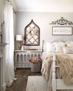 a bedroom with a white bed and wooden floors