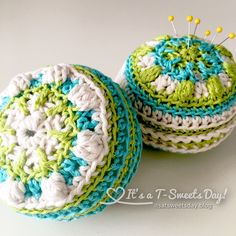 two crocheted balls sitting next to each other