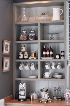 the shelves in this kitchen are filled with tea and coffee cups, mugs and saucers