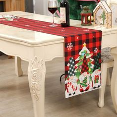 a table with a christmas themed runner on it