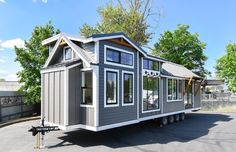 a tiny house is parked in the parking lot