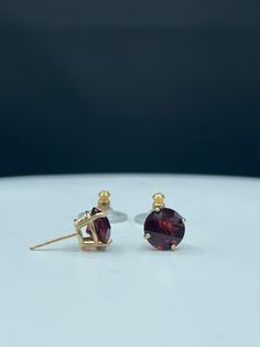 Discover the elegance of these stunning 4.25 carat natural garnet stud earrings. Featuring beautifully matched checkerboard cut garnets, these earrings sparkle with vibrant red hues. Each garnet is set in a heavy 14k yellow gold double basket setting, providing both security and a luxurious finish. The posts are stamped with 14k, ensuring their authenticity and quality. Measuring 8 MM in diameter, these garnet earrings are the perfect size to make a statement without being overwhelming. The hypoallergenic comfort backs are designed to prevent drooping, making these earrings comfortable to wear all day. Perfect for any occasion, these earrings add a touch of sophistication and glamour to your jewelry collection. Treat yourself or a loved one to this exquisite pair of garnet stud earrings to Yellow Gold Stud Earrings, Earrings Sparkle, Basket Setting, Sparkle Earrings, Yellow Gold Setting, Gold Stud Earrings, Garnet Earrings, Gold Stud, Stone Cuts