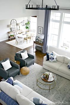 a living room filled with furniture and lots of windows