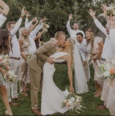 a bride and groom are surrounded by their wedding party