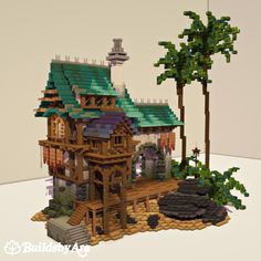 an image of a house made out of legos on display with trees and rocks