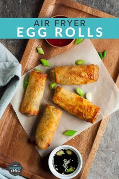 air fryer egg rolls on a cutting board with dipping sauce