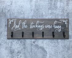 a wooden sign that says and the stocking were hung up on it's hooks