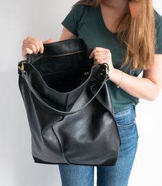 Oversize style Leather handbag made of 100% high quality soft cattle leather. LARGE and very roomy LEATHER Hobo BAG Fits all size laptops, room for a couple of books, wallet Brass Color Hardware adds style to the shoulder bag. This Leather Hobo handbag is very big and roomy! Top of the shopper bag has zipper closure - keeps your important stuff safe. Inside the shopper bag there is a pocket with zipper - for your keys, lip gloss, iPhone, glasses The bag can be worn on the shoulder. DIMENSIONS: H Large Shopper Bag, Oversize Style, Mulberry Bag, Large Hobo Bag, Leather Hobo Handbags, Black Leather Handbag, Oversize Fashion, Beautiful Handbags, Black Purse