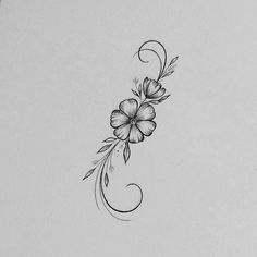 a black and white flower tattoo design on the back of a woman's shoulder