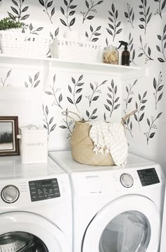 a washer and dryer sitting next to each other in front of a wall