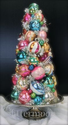 a christmas tree made out of ornaments on top of a silver plated platter