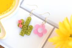 "♥ Cactus flower mis match earrings ♥ ♥ Cute cactus flowers ♥ Cactus size : 2\" ♥ Flower size: 1.5\" ♥ Earrings can be ordered as a mismatched pair, flower pair or a flower pair. ♥ Laser cut acrylic arrings designed and created by me These make arally cute gift for succulent and plant lovers, for plant moms, for people who love earrings! More earrings at my shop: etsy.com/shop/sehreensartlab" Spring Retro Flower Earrings Gift, Acrylic Flower Earrings, Fun Flower-shaped Earrings For Spring, Playful Flower-shaped Earrings, Pink Flower-shaped Earrings For Valentine's Day, Rain Jewelry, Mom Earrings, Kawaii Earrings, Dangle Hoop Earrings