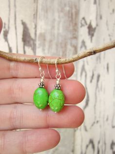 "These simple dangle earrings are made from green turquoise oval howlite stones. A very pretty color of apple green turquoise. They are accented with Bali silver spacers and sterling finishing beads. They measure 1 1/8\" from the top of the sterling silver earwires. Make it a set, see the matching NECKLACE here: https://www.etsy.com/listing/240376982/triple-strand-green-turquoise-necklace?ref=shop_home_active_21 All my jewelry comes gift boxed with a bow ready for gift giving whether it is a gif Green Oval Hypoallergenic Earrings, Hypoallergenic Green Oval Earrings, Green Oval Earrings With Natural Stones, Green Oval Nickel-free Earrings, Oval Green Earrings With Natural Stones, Hypoallergenic Turquoise Oval Earrings, Simple Dangle Earrings, Howlite Jewelry, Turquoise Dangle Earrings