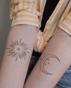 two people with matching tattoos on their arms, one has a sun and the other has a moon